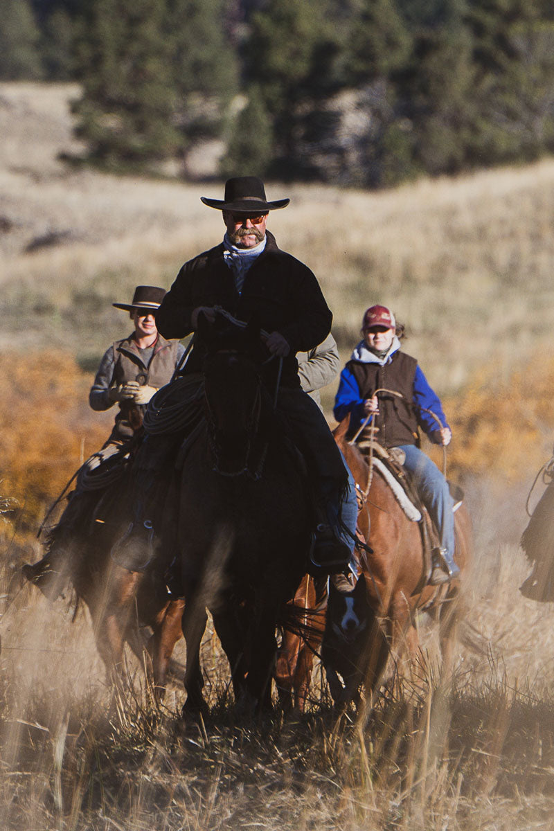 The Real Yellostone Film - Four cowboys riding through a ranch